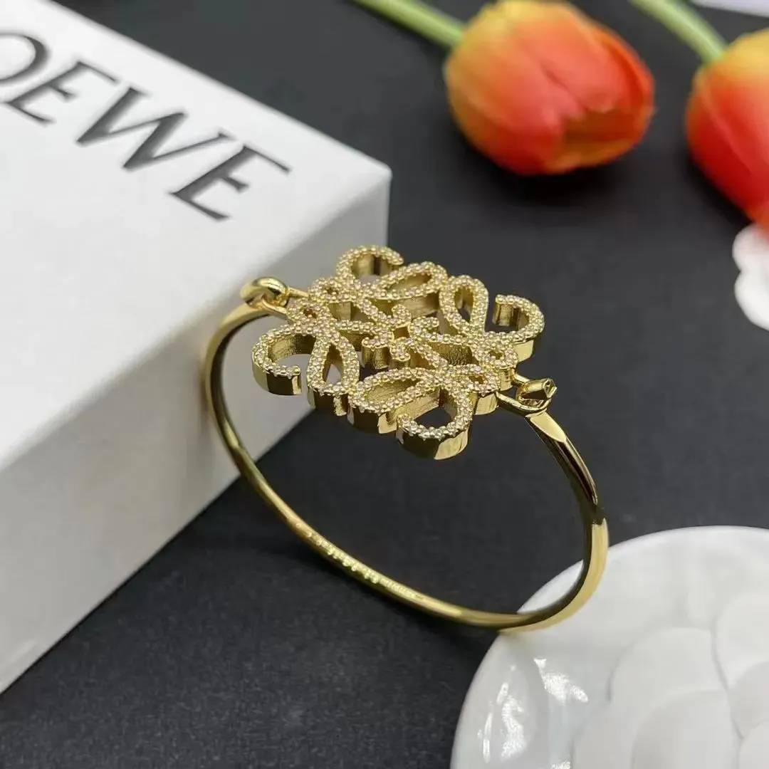 Luxury Gold Tone Cuff Bracelet with Intricate Floral Design